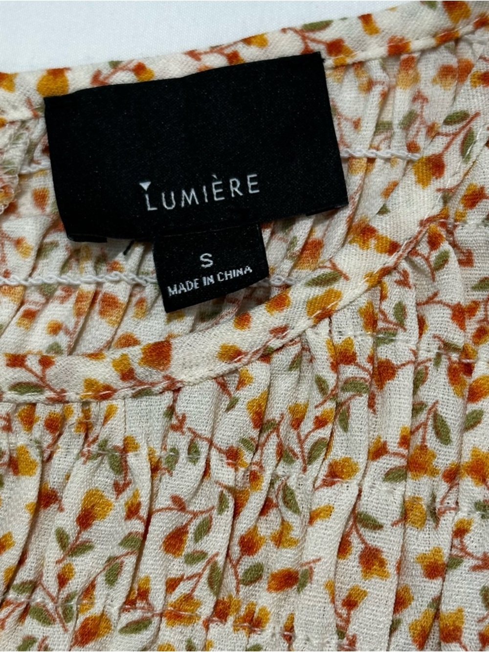 Lumiere long sleeve feminine Floral Print Smocked Peplum Top. 
Size: Small - Picture 11 of 11